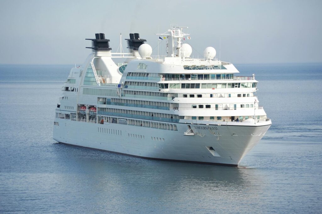 white cruise ship on blue body of water during daytime