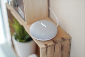 round grey speaker on brown board