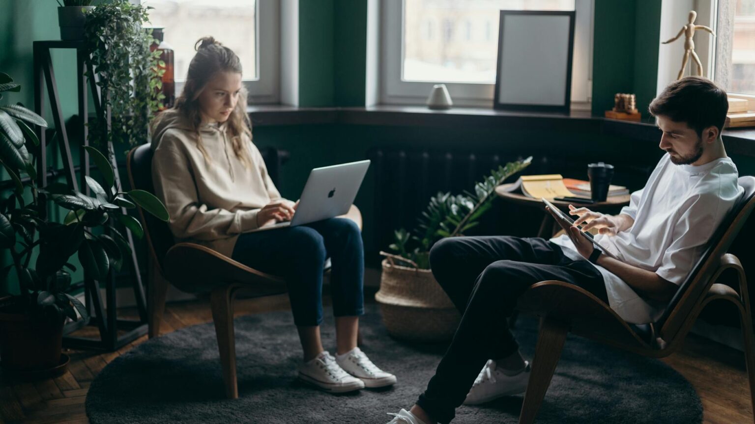 photo of two people using their gadgets