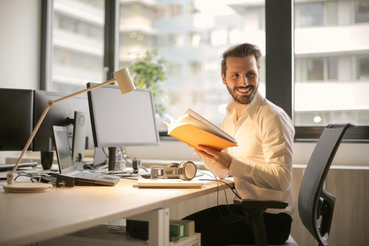 photo of man holding a book