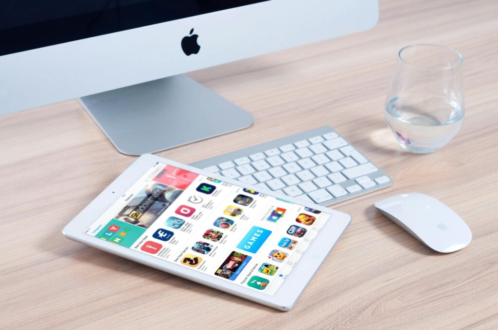 white tablet computer on apple magic keyboard near apple magic mouse