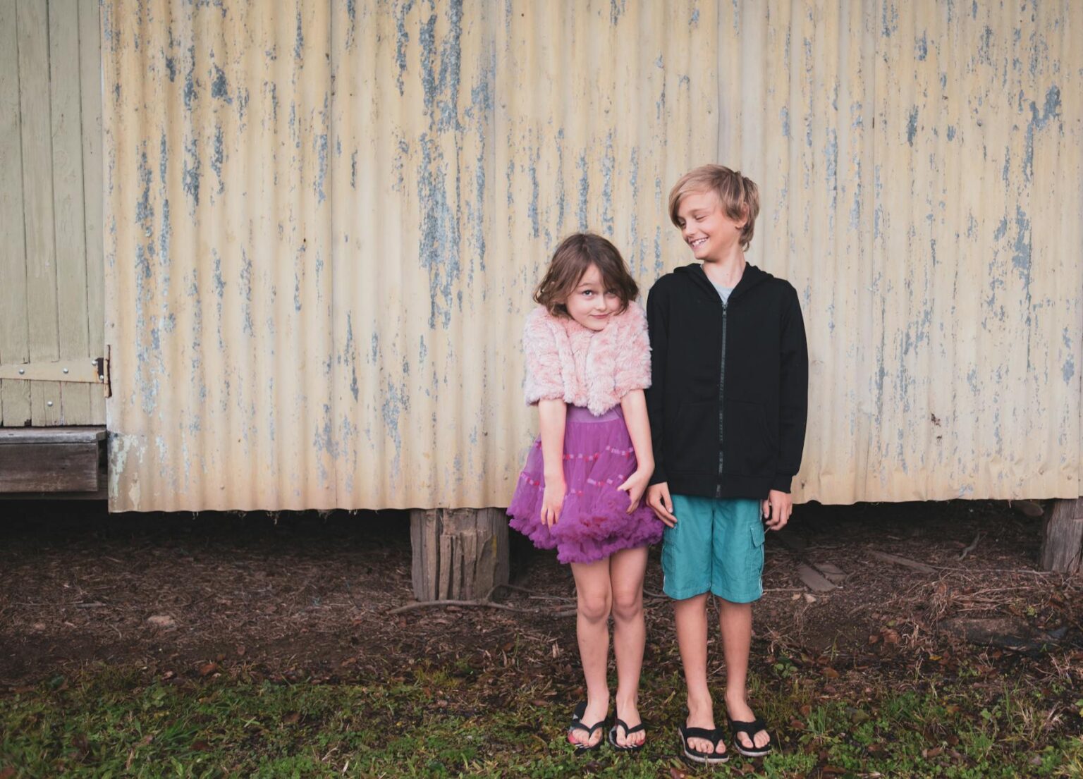 boy and girl standing on wall