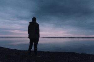 person standing near lake