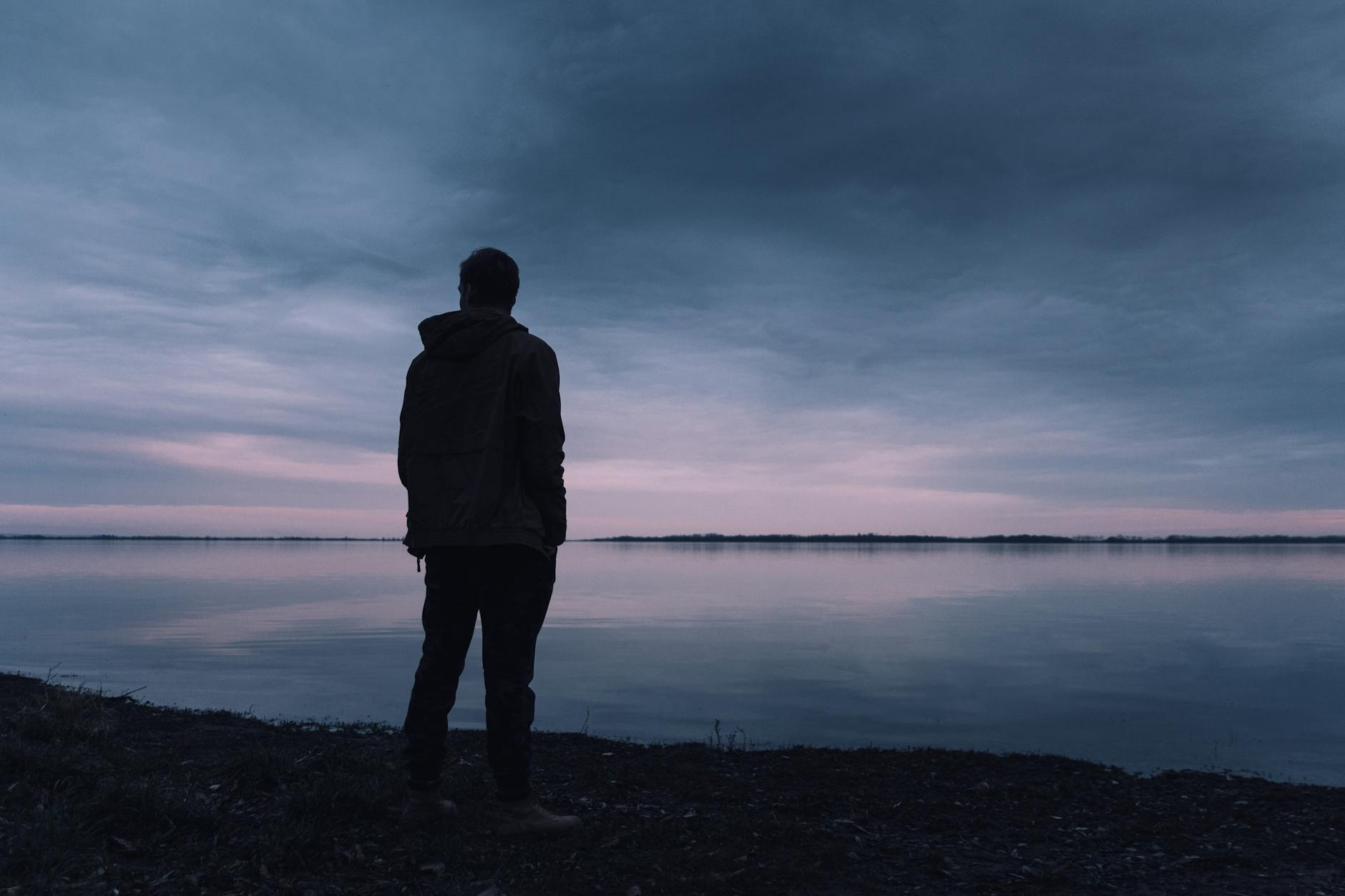 person standing near lake