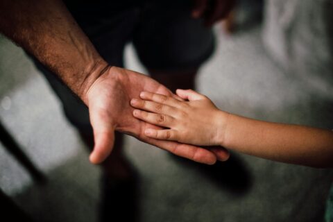 father and child s hands together