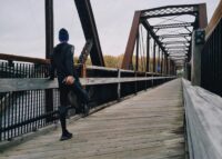 man standing on bridge