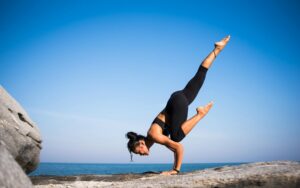 low angle view of woman relaxing on beach against blue sky