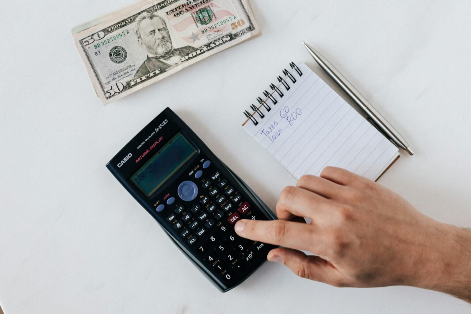 crop faceless accountant using calculator while making budget