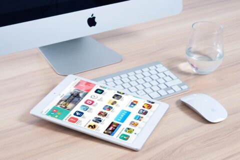 white tablet computer on apple magic keyboard near apple magic mouse