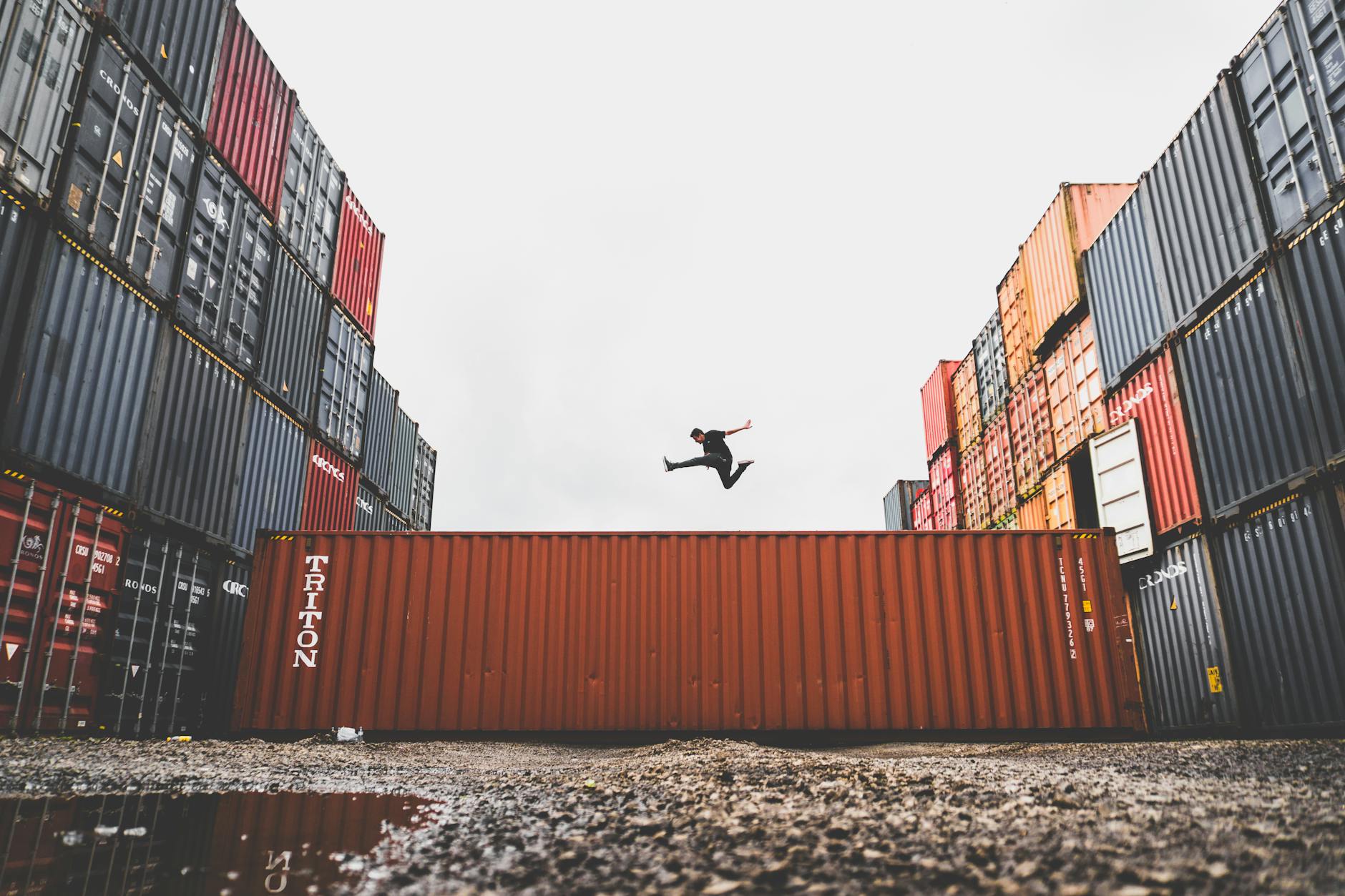 man jumping on intermodal container