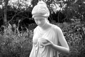 woman holding bowl statue