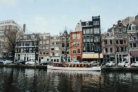 white and brown wooden boat on body of water