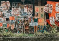 woman standing in front of paintings