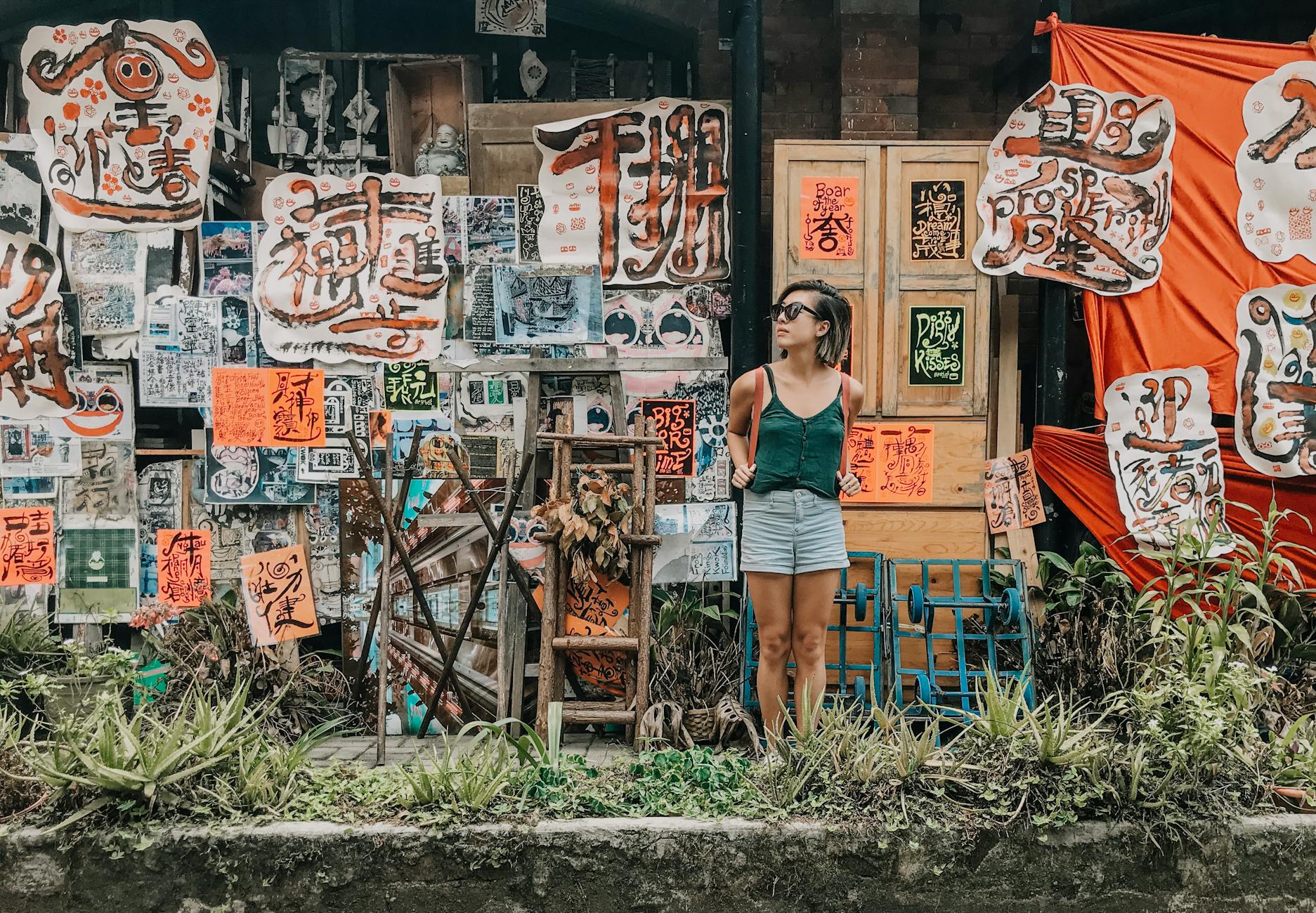 woman standing in front of paintings