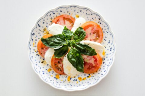 vegetable salad on white and blue round floral plate