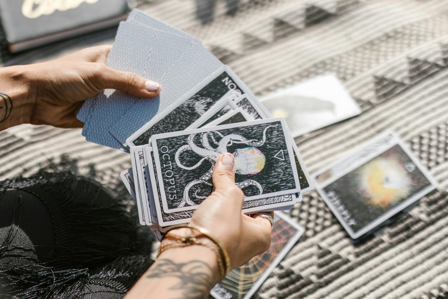 person holding white and black book